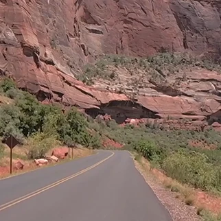 A road winding through the red rock of Zion National Park