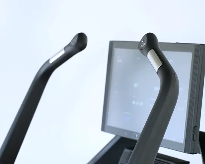 Close-up of the Aviron Summit Treadmill hiking handles beside the touchscreen